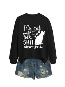 Detail of black cotton sweatshirt featuring cat silhouette and funny quote with denim shorts