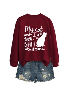 Close-up of 'My cat and I talk SHIT about you' lettering on a burgundy sweatshirt