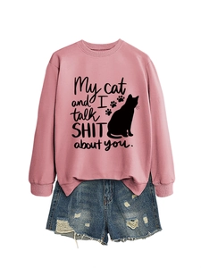 Close-up of pink crewneck sweatshirt featuring My Cat and I Talk Shit About You print