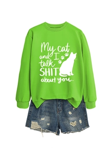 Neon green sweatshirt with cat silhouette print and distressed denim shorts on white background