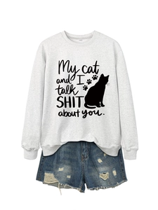 Detail view of light grey sweatshirt featuring humorous cat print and slogan design