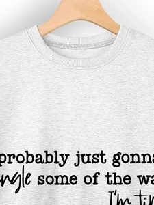 Detail of grey crewneck sweatshirt showing ribbed collar and probably just gonna text print