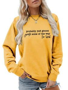 Detail of yellow pullover sweatshirt with black typography art print and ribbed cuffs