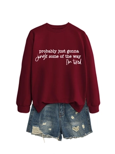 Detail of burgundy holiday sweatshirt with jingle typography and denim shorts