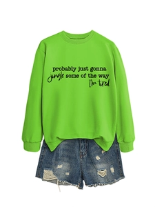 Detail of neon green crewneck sweatshirt featuring black graphic text and ribbed cuffs