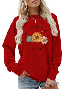 Detail view of red crewneck sweatshirt featuring floral print and Have the Day You Deserve text