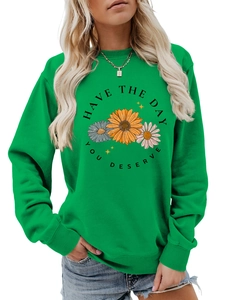 Close-up of ribbed cuffs and daisy graphic on this green crewneck sweatshirt