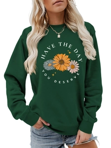 Detail of dark green crewneck sweatshirt with sunflower print and inspirational slogan