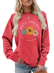 Detail of red crewneck sweatshirt with sunflowers and Have The Day You Deserve slogan