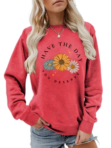 Detail of floral graphic print and quote on crewneck sweatshirt in brick red color