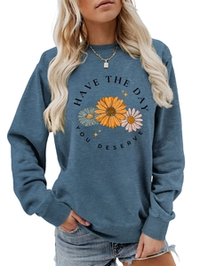Detail of floral daisy print and motivational quote on navy blue crewneck sweatshirt