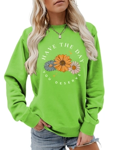 Detail of bright green crewneck sweatshirt with sunflower print and slogan text