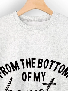 Close-up of ribbed crewneck and From The Bottom Of My Heart text on gray sweatshirt