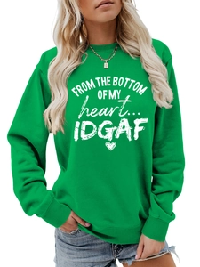 Close-up of vibrant green sweatshirt featuring white heart letter graphic and ribbed cuffs