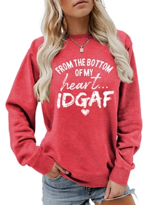 Detail of red crewneck sweatshirt featuring white artistic letter print and ribbed cuffs