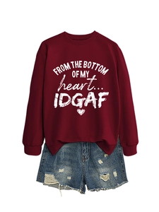 Detail of burgundy sweatshirt featuring heart print and denim shorts outfit set