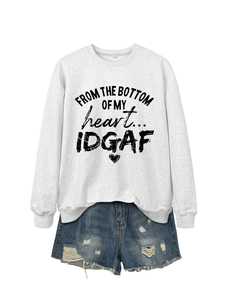 Close-up of gray sweatshirt with FROM THE BOTTOM text and distressed denim shorts