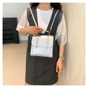 Chic silver metallic mini backpack for women featuring golden clasps and top handle