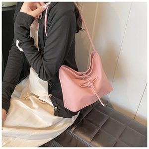 Pink PU leather shoulder bucket bag with decorative rope knot and magnetic closure