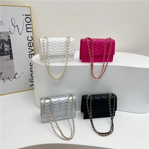 Chic quilted crossbody chain bags in white, pink, silver and black displayed on pedestals