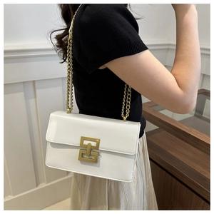 Detail of white leather crossbody bag with golden chain strap and geometric metal buckle