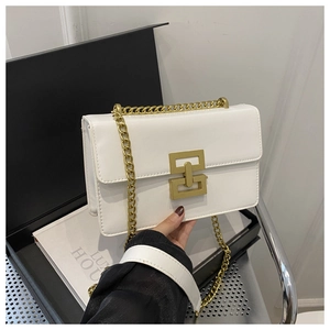 Detail of white leather crossbody bag with golden geometric lock and chain strap