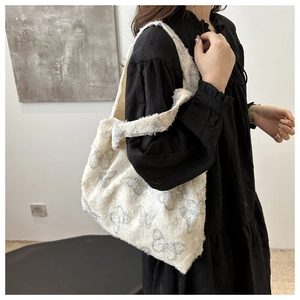 Large white faux fur tote bag with butterfly prints shown on model for daily commuting