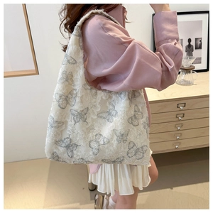 Chiffon shoulder tote bag with butterfly patterns shown in a stylish indoor setting