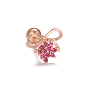 Detail of rose gold bear ear piercing with vibrant pink zircon stone cluster and ball screw back