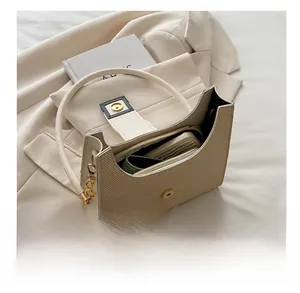 Top view of woven beige handbag interior showing spacious capacity and gold chain