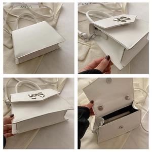 Detail view of white PU leather crossbody bag with silver bow buckle and interior space