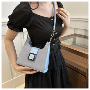 Blue woven texture shoulder bag with light blue leather trim and golden chain strap