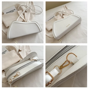 Detail view of white irregular hobo bag with gold hardware and logo engraving