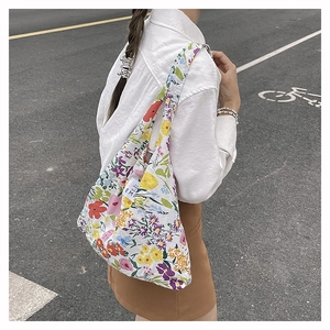 Detalle de la etiqueta EMI en un bolso shopper ligero de nailon con flores para mujer