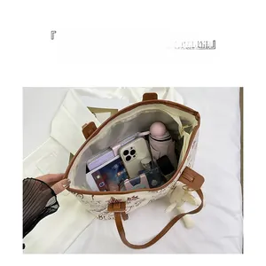 Top macro view showing large tote bag interior with tablet and organized items