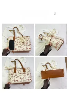 Detailed views of contrast color tote bag with cartoon graffiti print and bunny charm