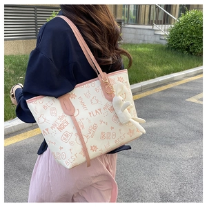 Chic graffiti tote bag in cream and pink with cute bunny charm for women's daily fashion