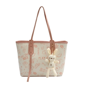Graffiti tote bag with pink letter print and cute rabbit pendant on white background