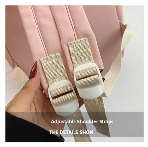 Close-up of adjustable pink nylon backpack straps with white buckles and fine stitching