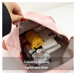 Internal view of the pink nylon backpack showing its large storage capacity and compartments