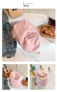 Detailed view of pink lightweight waterproof nylon backpack with drawstring and logo