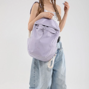Light purple waterproof nylon backpack with drawstring closure and B.a.g logo on model