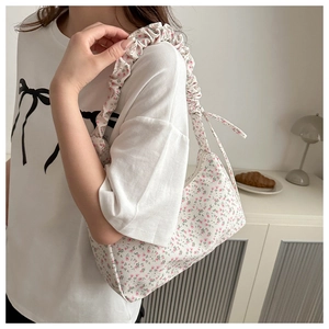 Close-up of floral Oxford fabric underarm bag with unique ruched shoulder strap detail