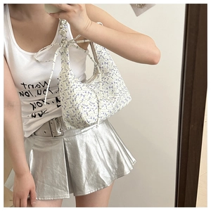 Close-up of floral shoulder bag with ruched scrunchie strap and ribbon bow detail