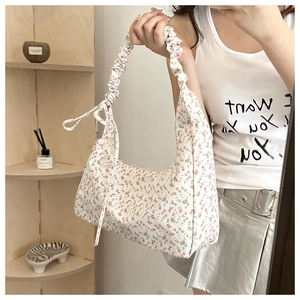 Close-up of floral oxford cloth bag with cloud pleated strap and sweet ribbon details