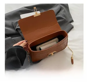Detail view of brown crocodile texture crossbody bag showing internal storage capacity