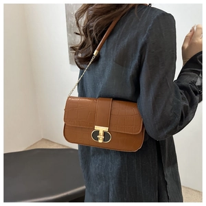 Brown crocodile embossed underarm bag with gold chain strap and interlocking metal clasp