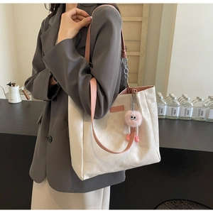 Large checkered tote bag with pink straps and plush charm for summer fashion commute