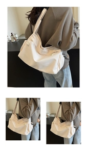 Detail of a cream nylon shoulder bag featuring adjustable straps and drawstring side pockets