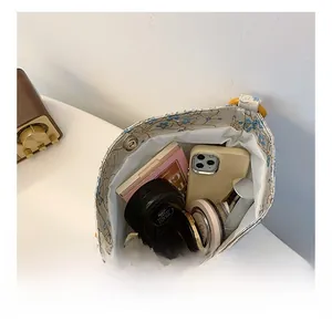 Interior view of silk bucket bag showing space for phone and cosmetics with wood beads
